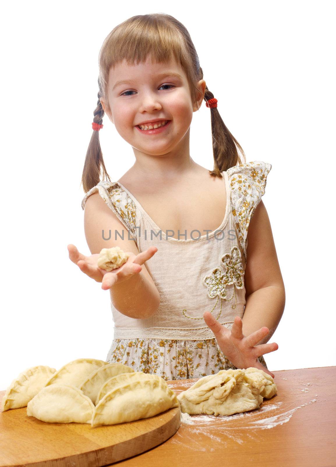 Smiling little girl kneading dough at kitchen with baking a pie. isolated on white