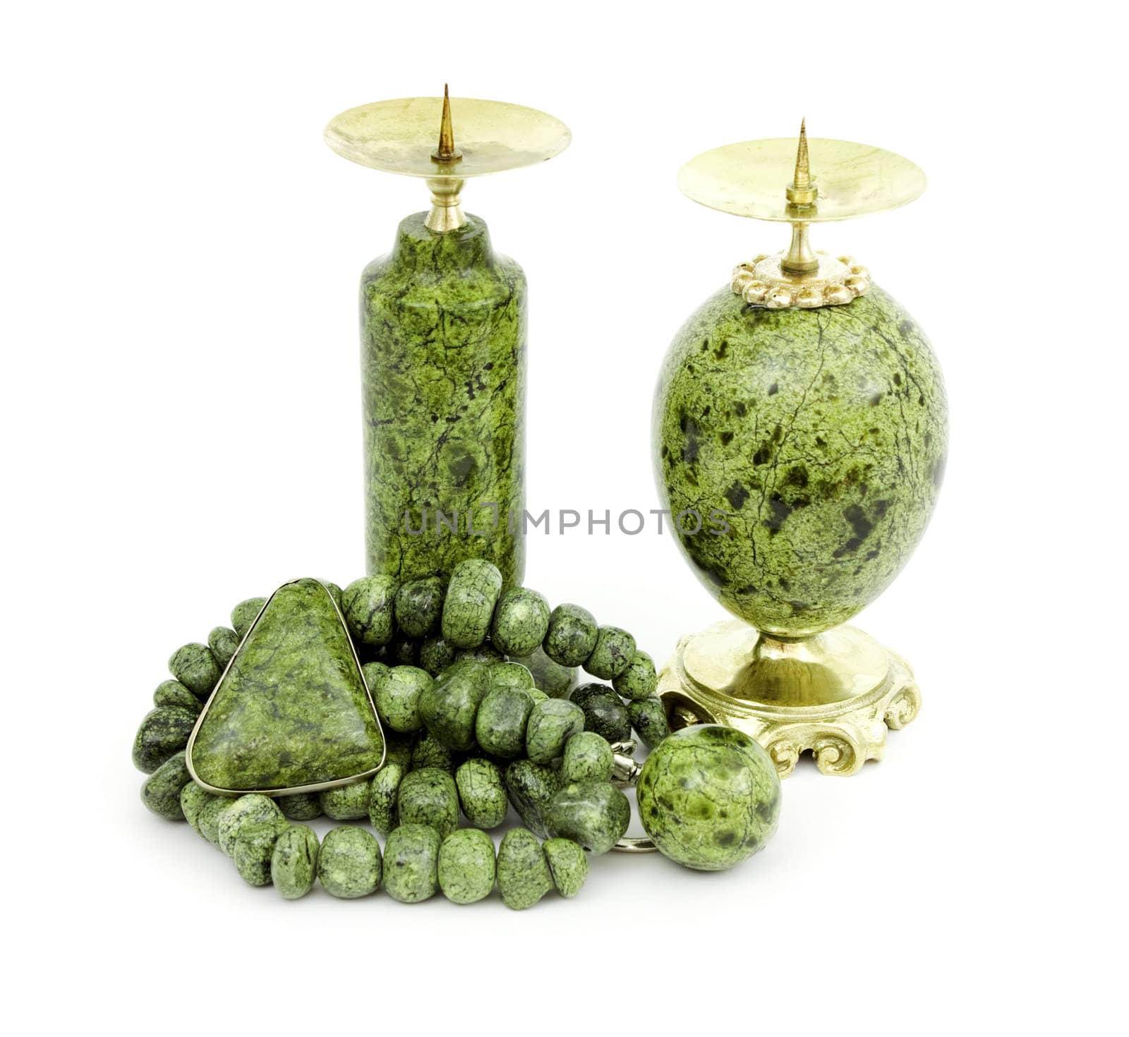Candle holders, necklaces and a brooch made of stone serpentine  isolated on white