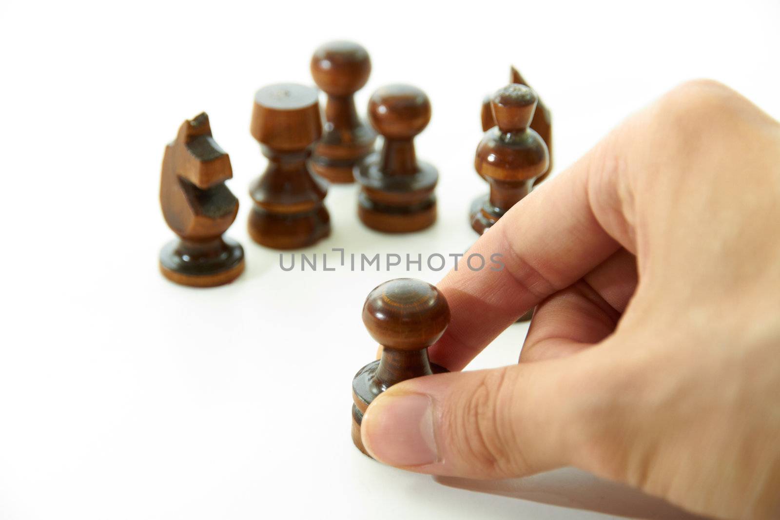 Chess pieces are holding by hand on white background