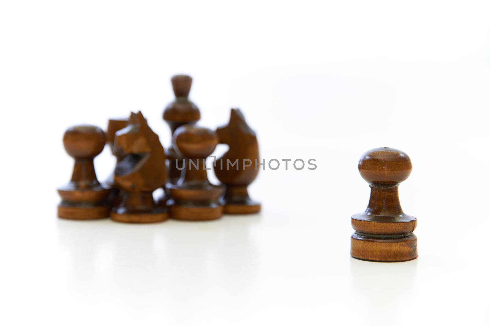 Chess pieces (pawn, knight, king) with the pawns leadership on white background