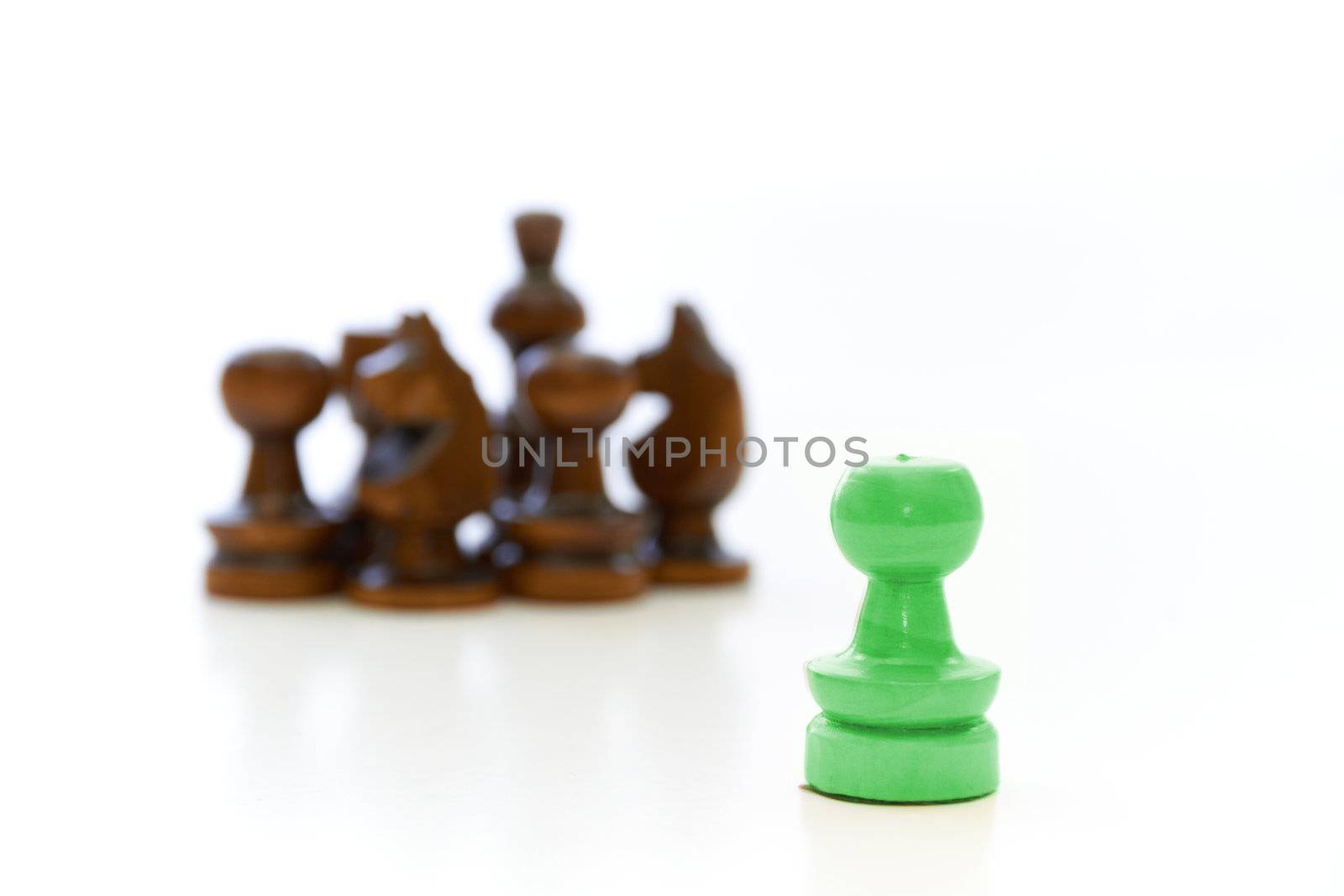 Chess pieces (pawn, knight, king) with a leader on white background