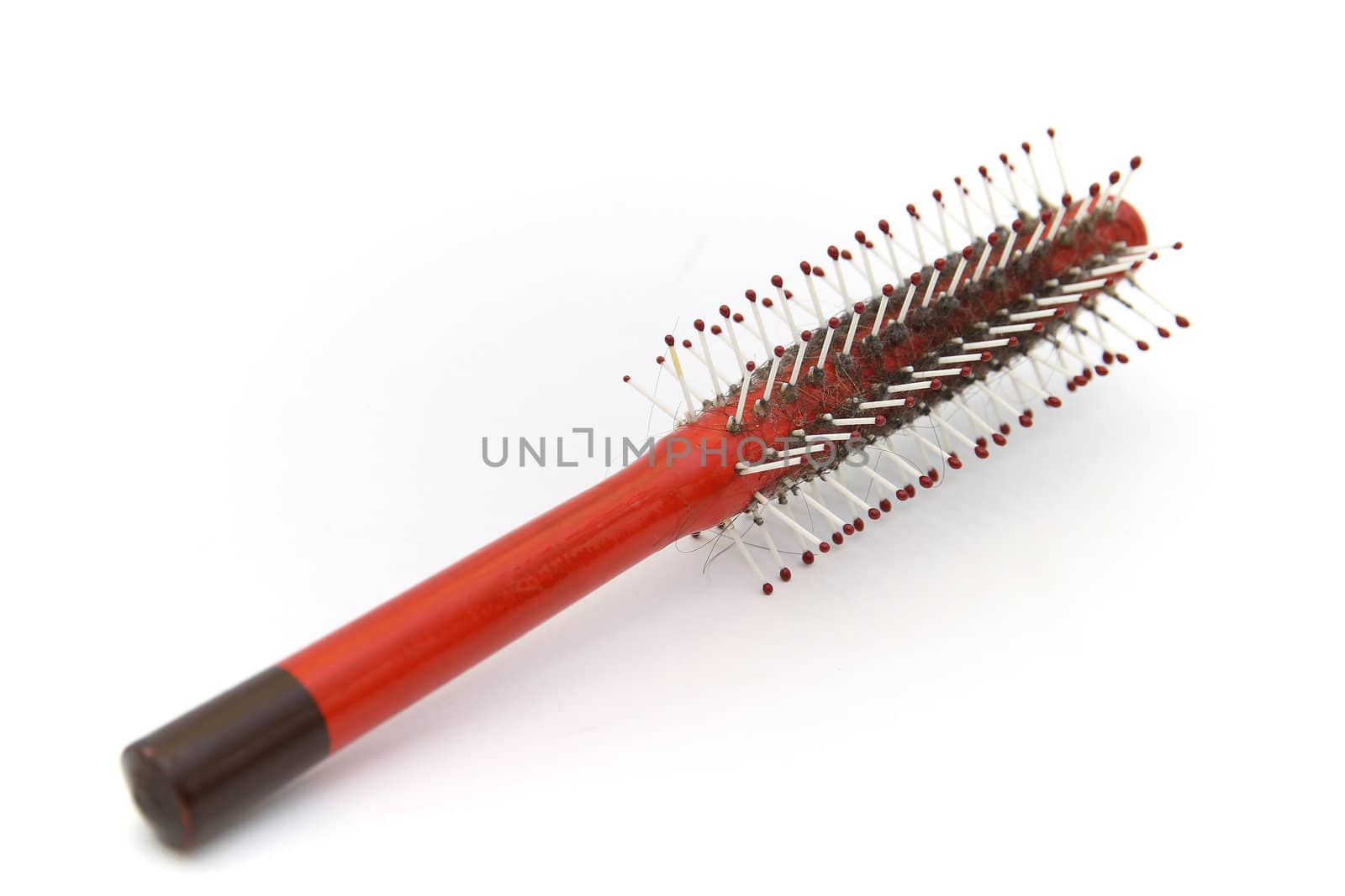 Plastic red dirty comb on white background.