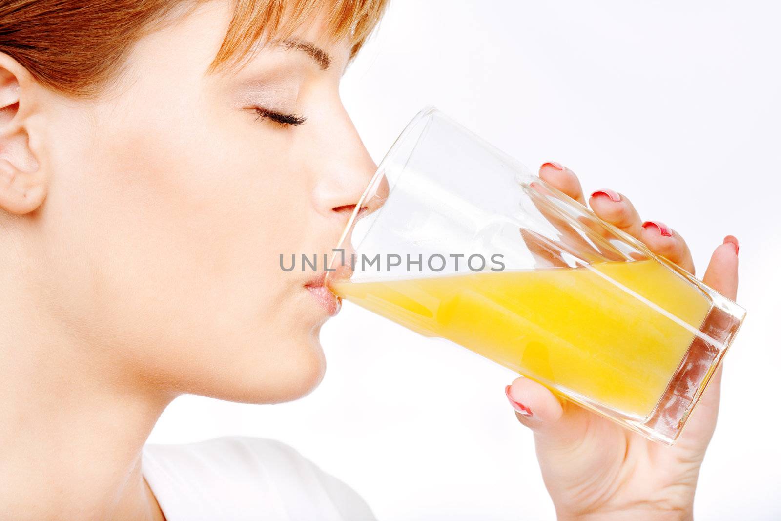 pretty woman with eyes closed drinking orange juice