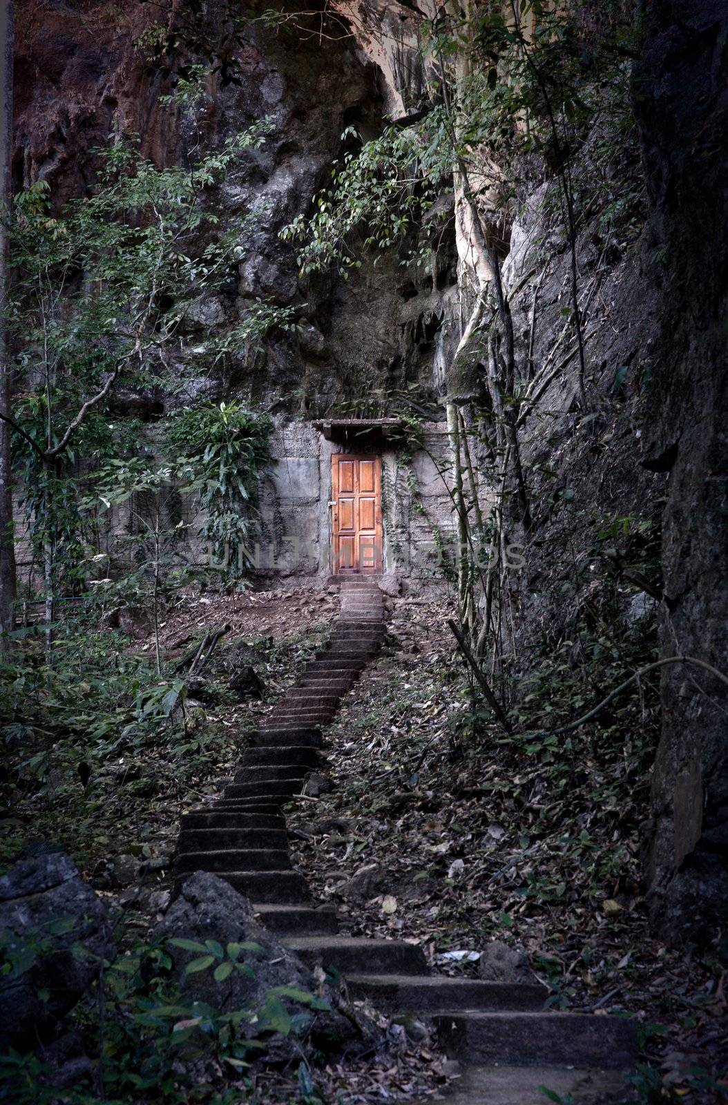 cabin door built into side of a dark mountain