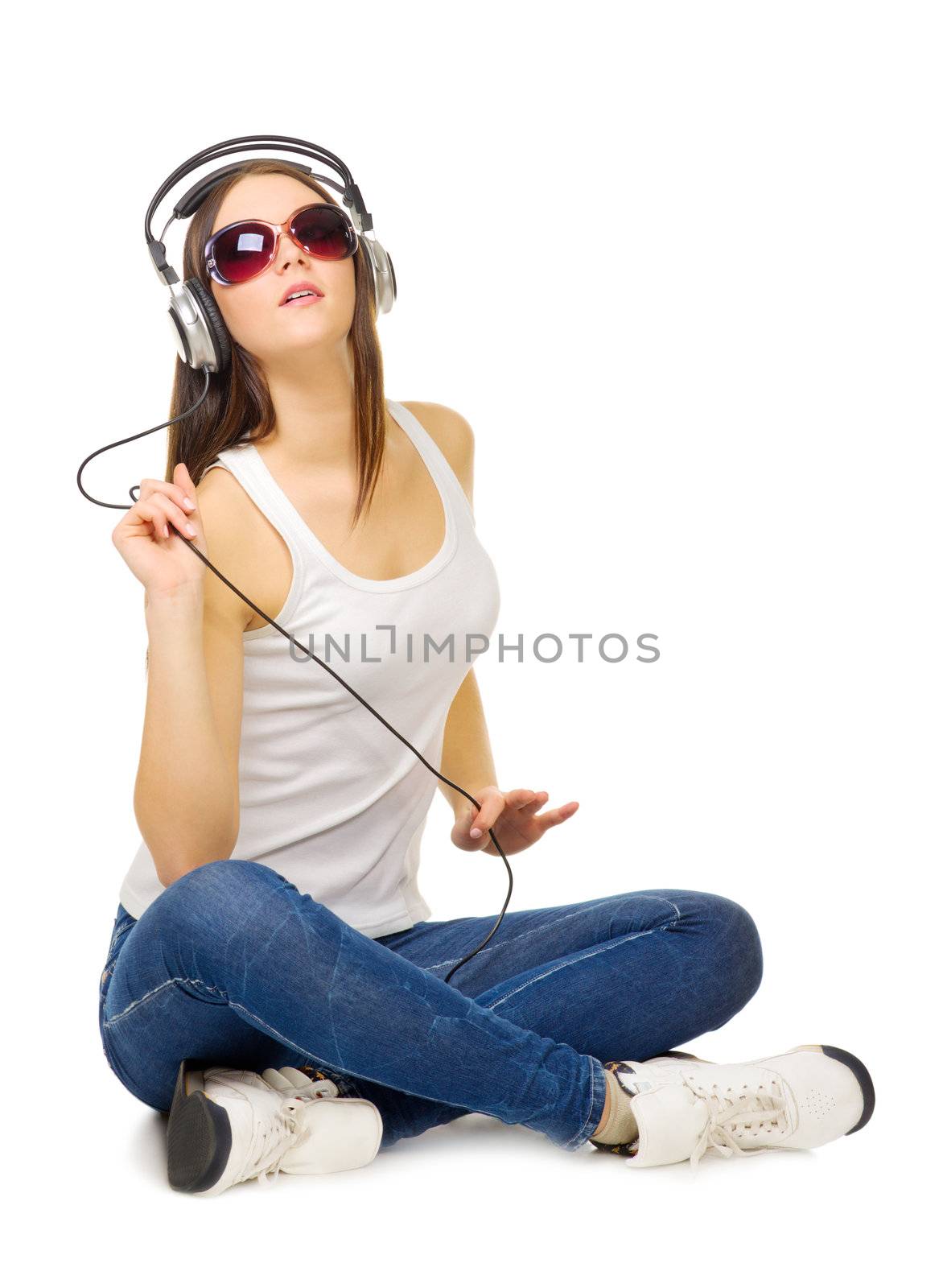 Young girl listen music by headphones isolated