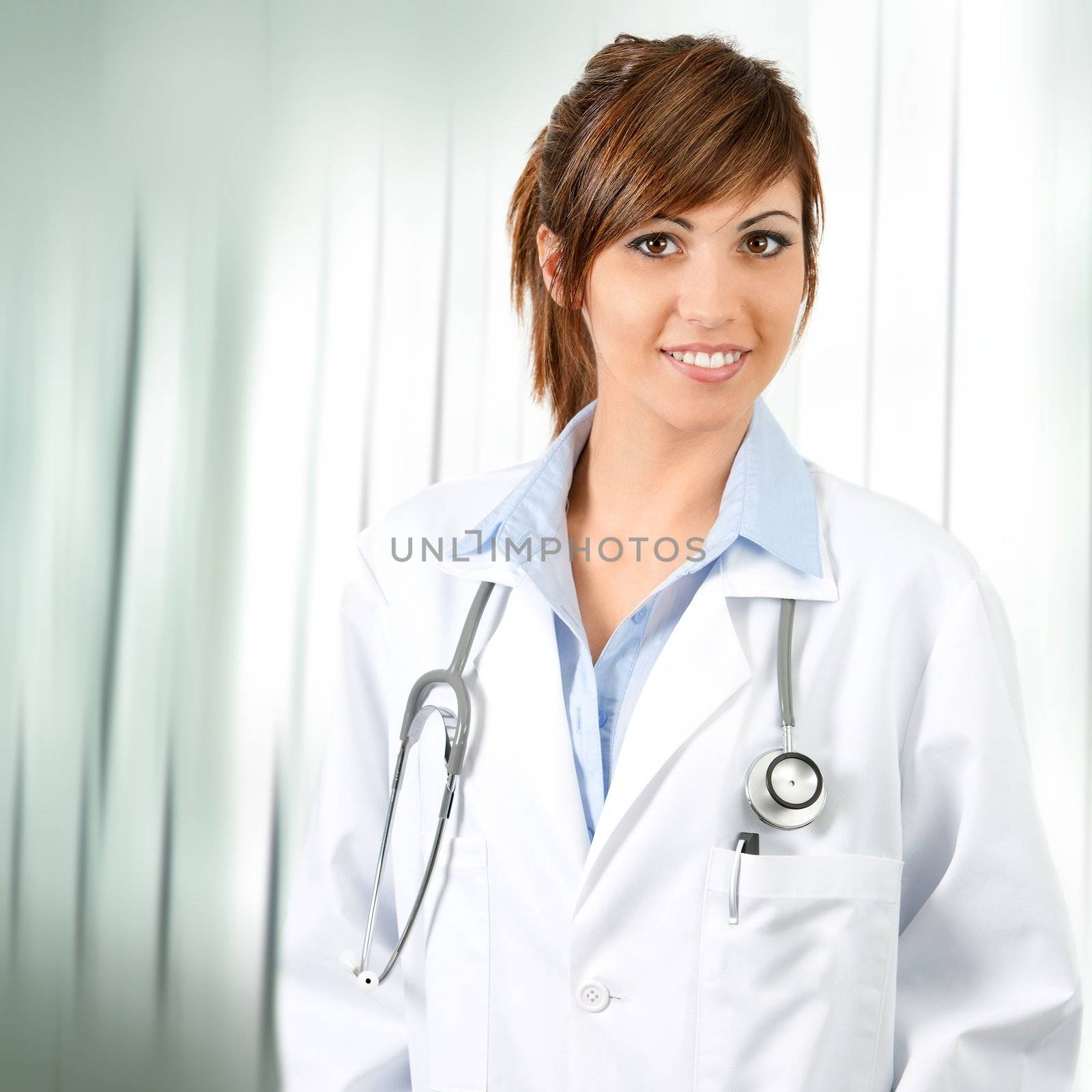 Attractive confident female doctor with stethoscope. by karelnoppe