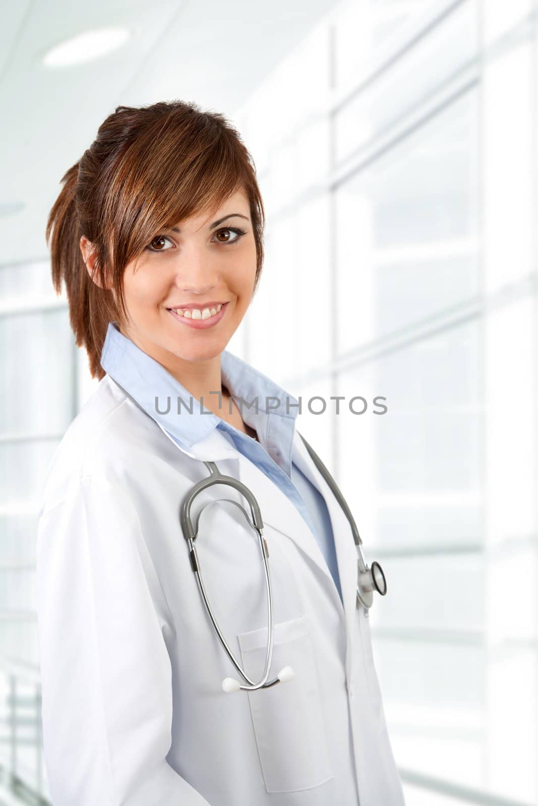Portrait of Attractive young female doctor with stethoscope  in hospital.
