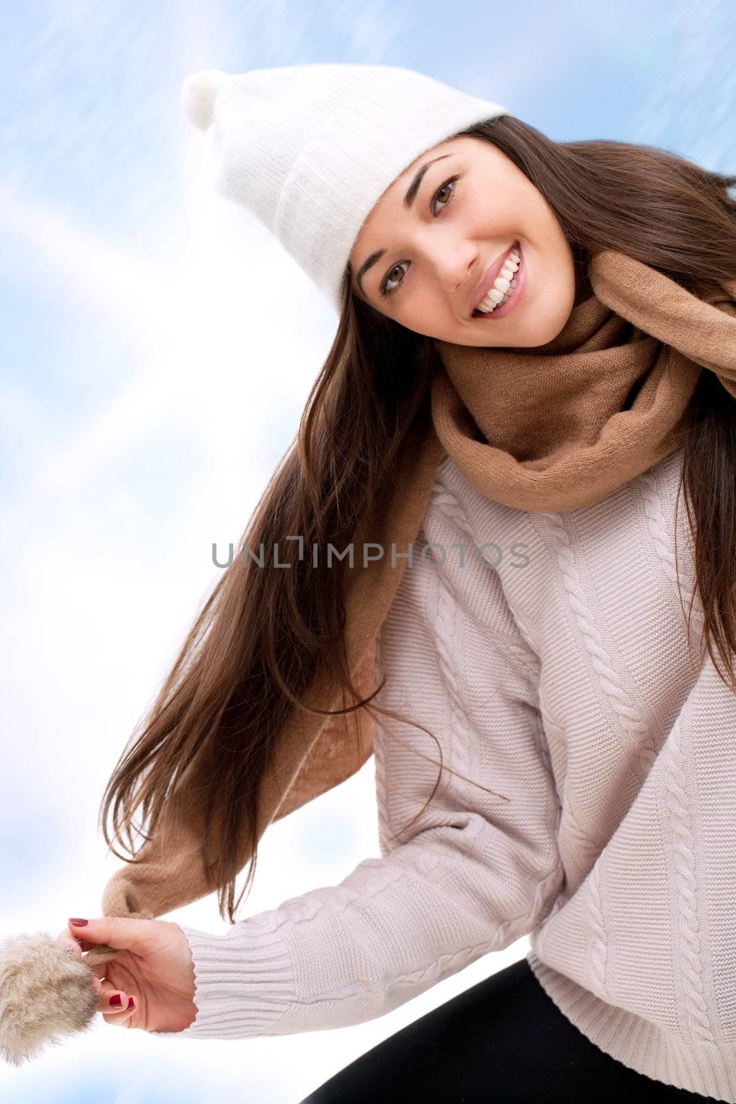 Young attractive winter girl having fun outdoors.