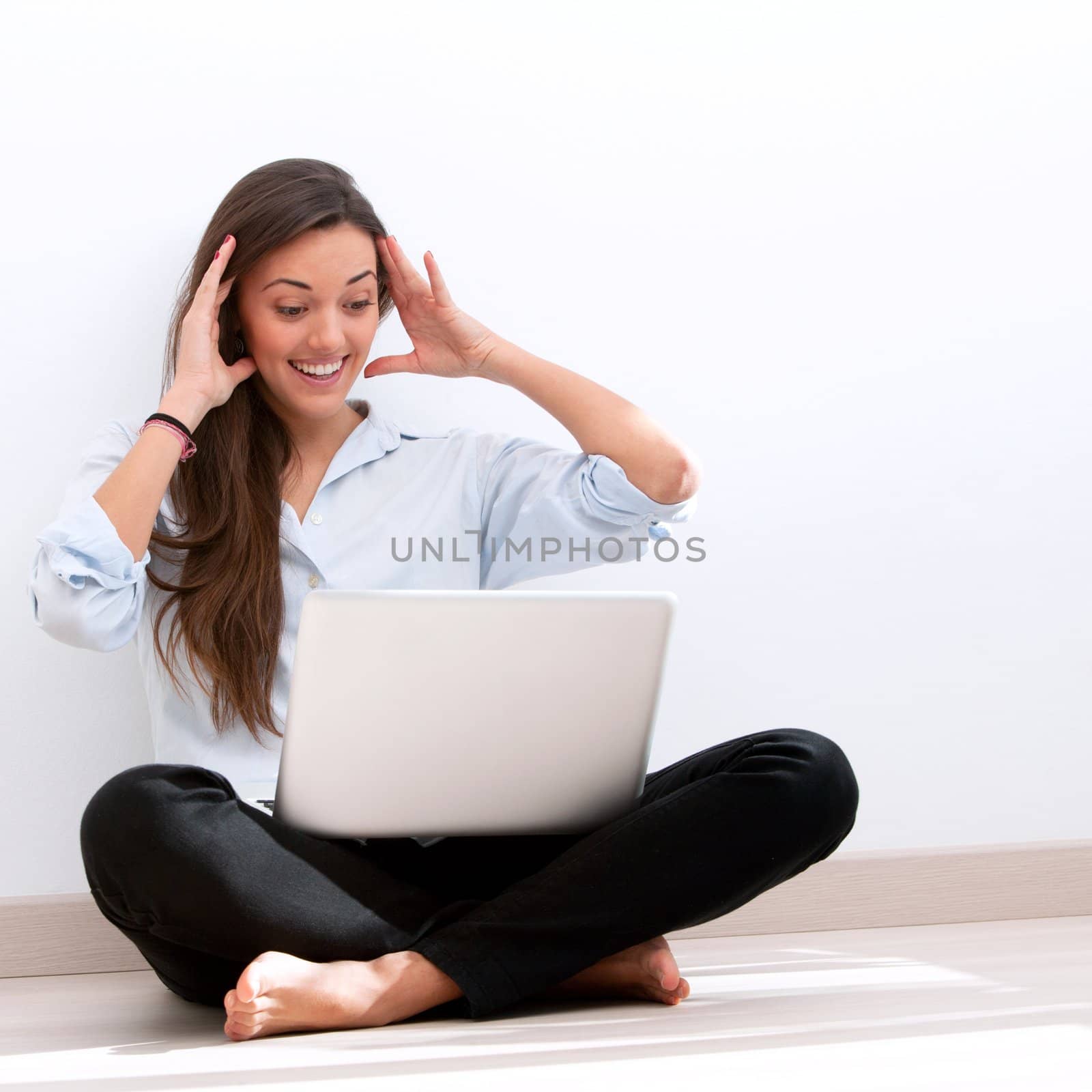 Girl sitting on floor with laptop by karelnoppe