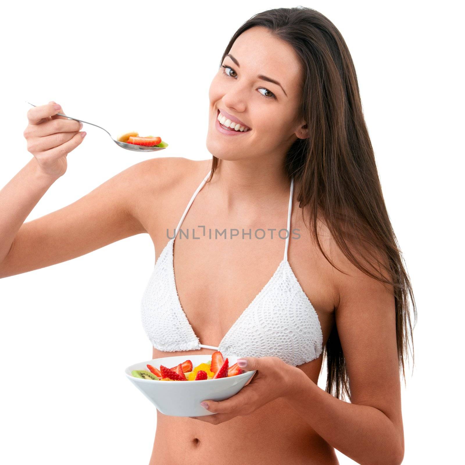 Young attractive woman eating fruit.Isolated