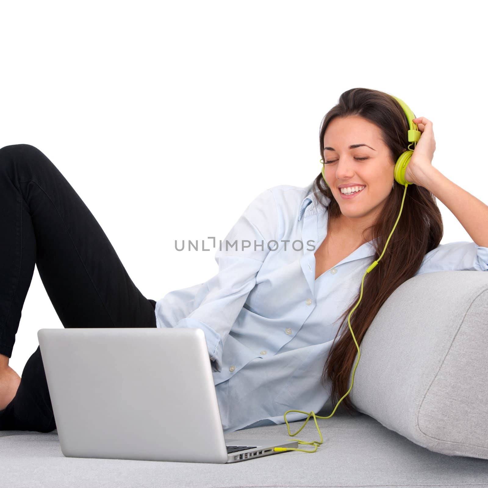 Young woman enjoying music with laptop by karelnoppe