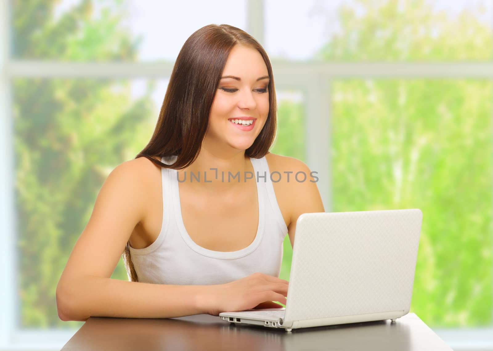 Young girl with laptop at home