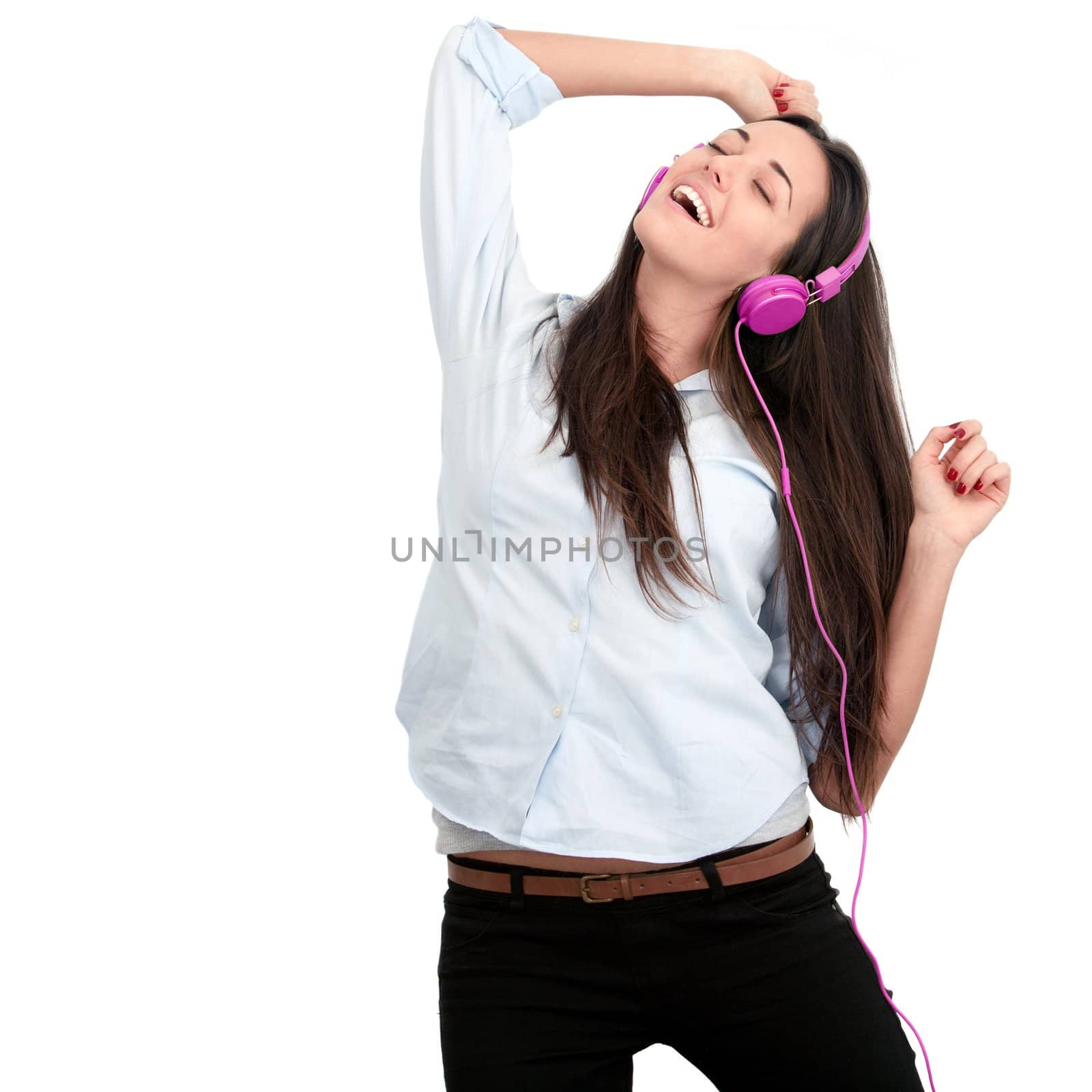 Young woman with pink headphones dancing.Isolated.