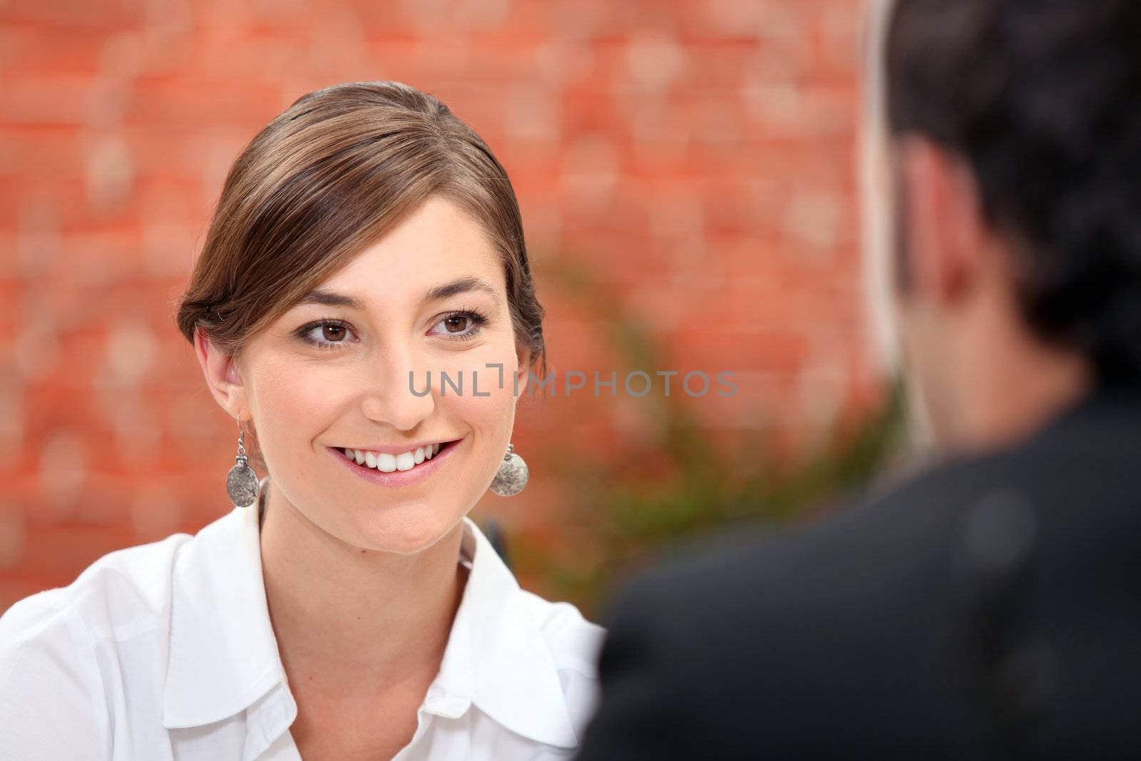 Woman smiling at her date by phovoir