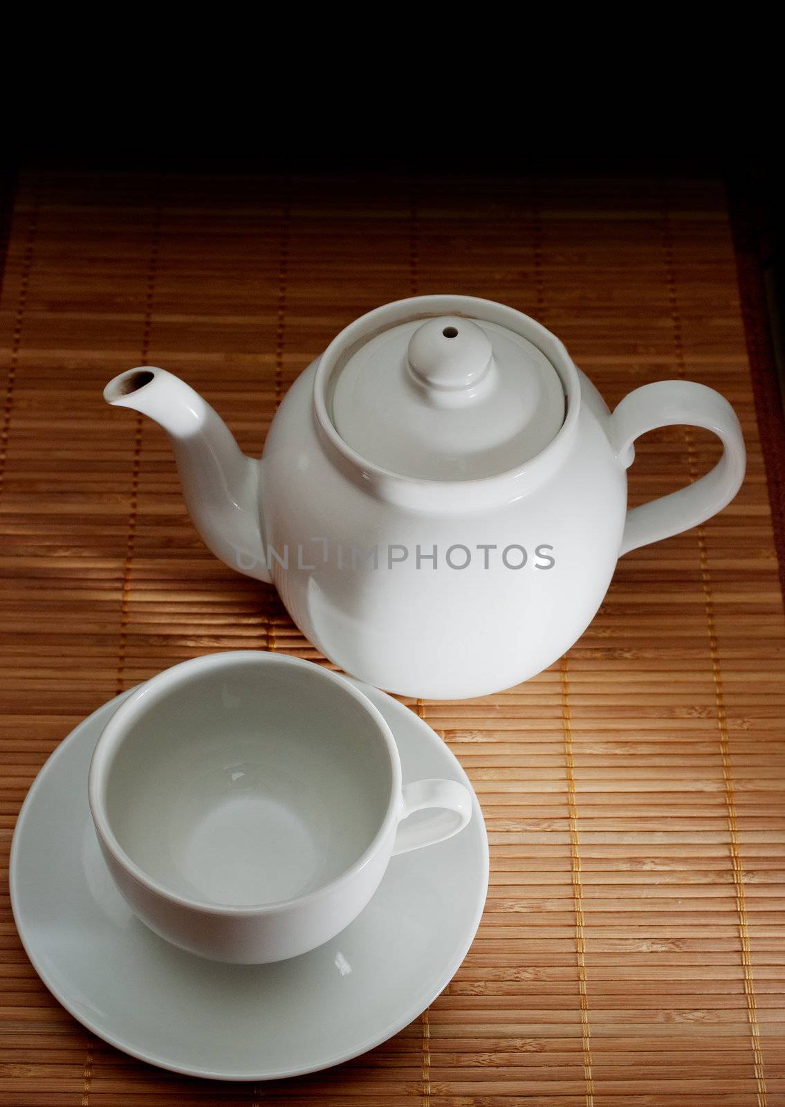 Cup and teapot on bamboo napkin