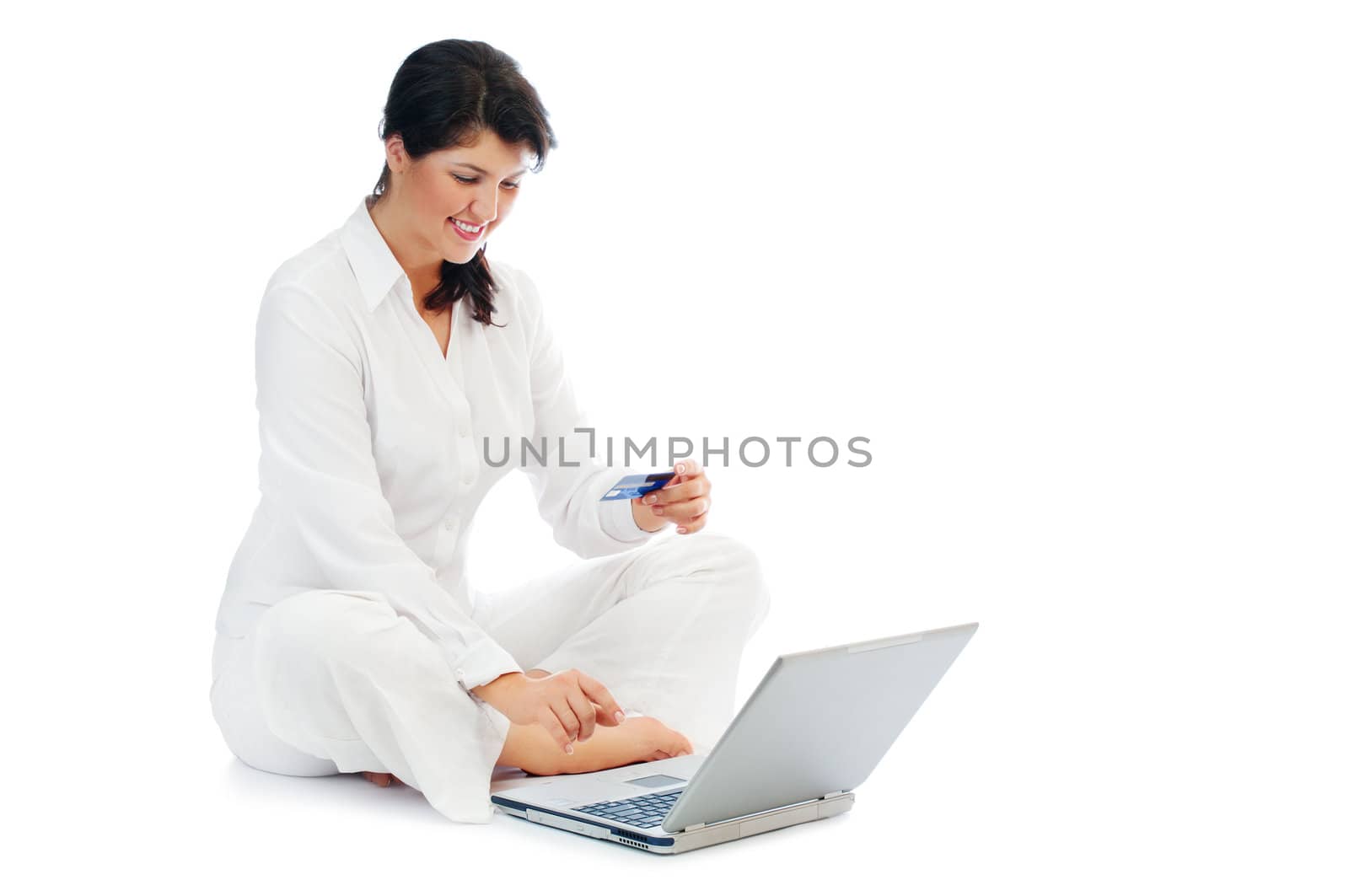 Smiling young woman with credit card and laptop isolated