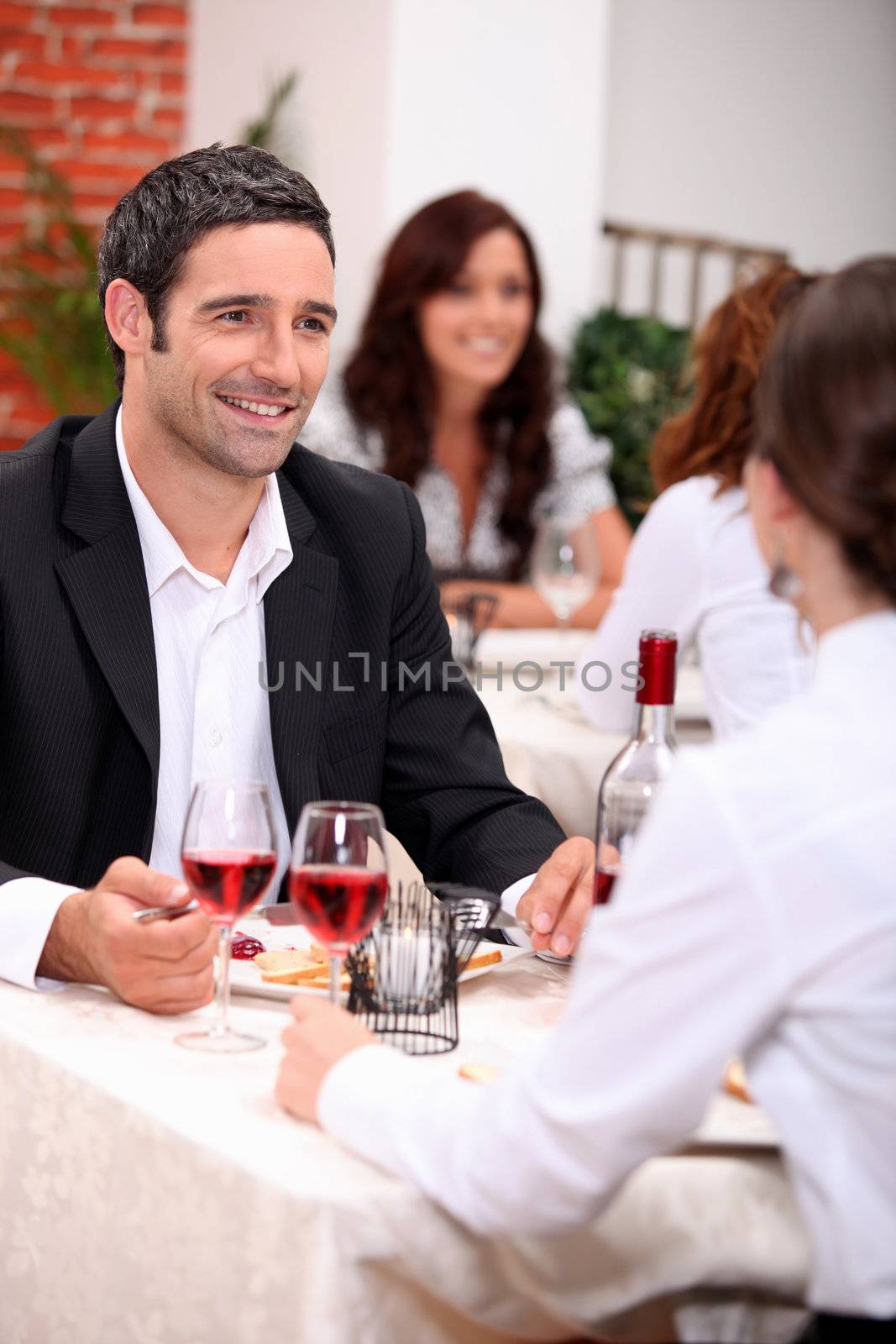 Couple enjoying a romantic meal together by phovoir