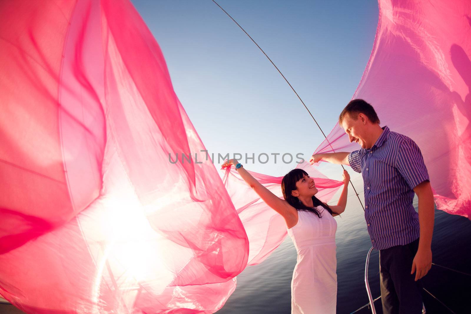 man and girl under the sail and sun