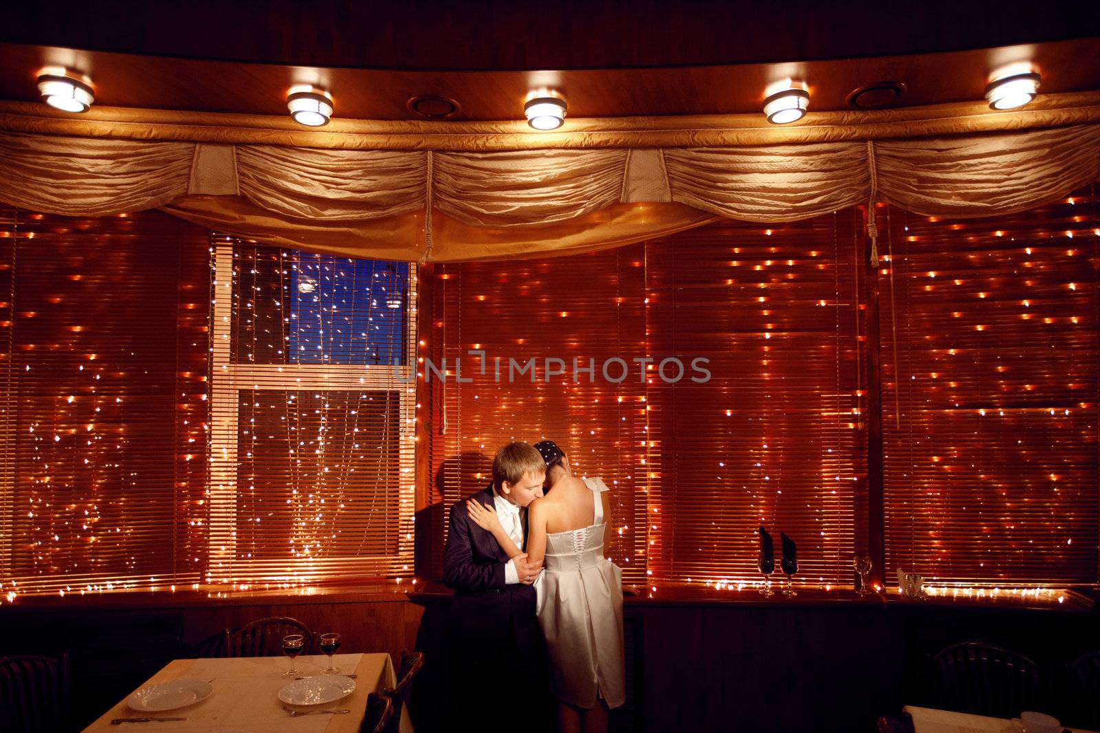 couple by the window with lights