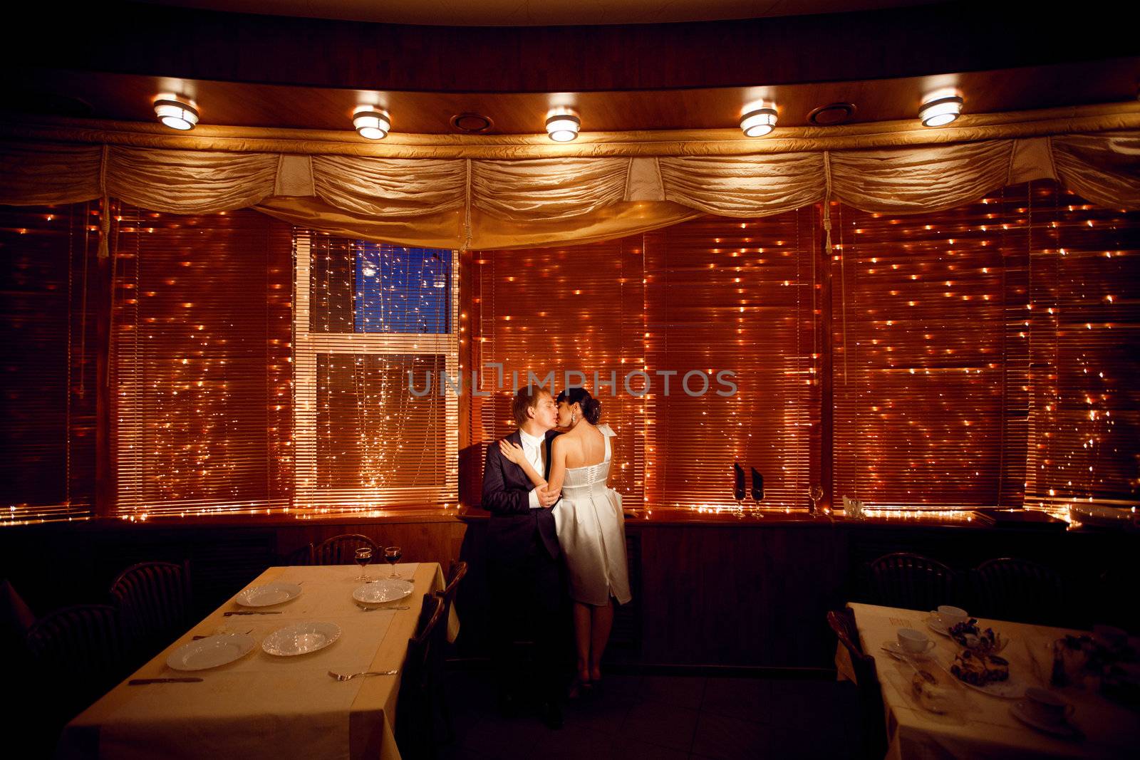 couple by the window with lights