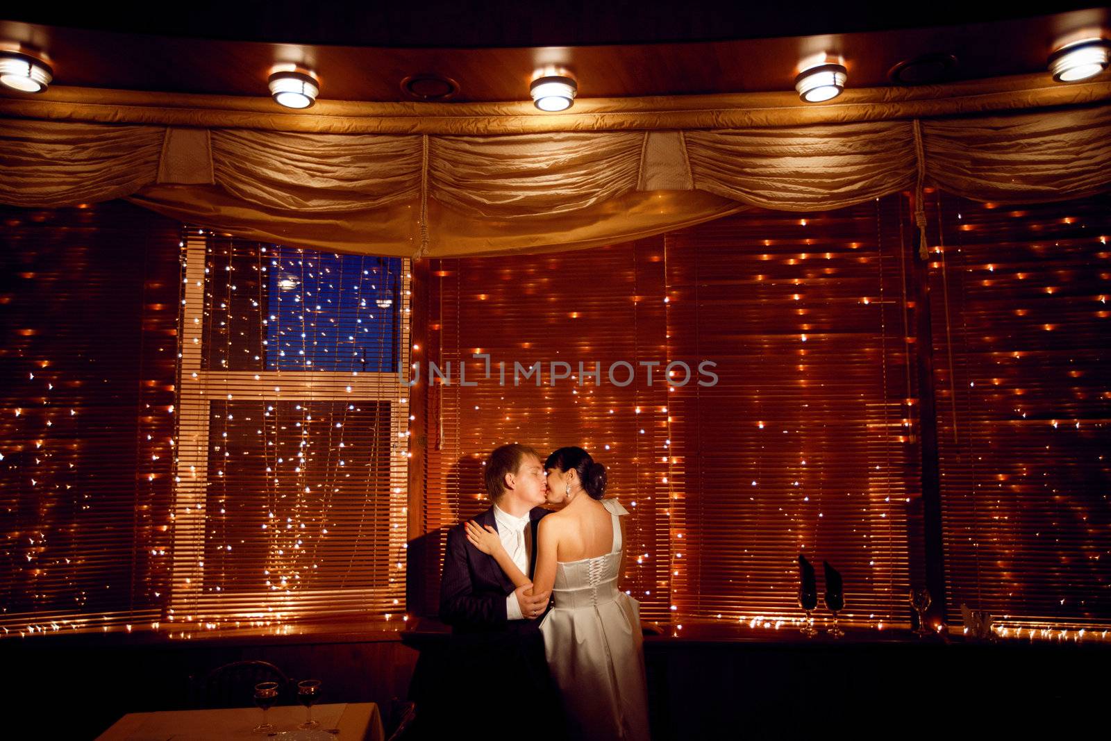 couple by the window with lights