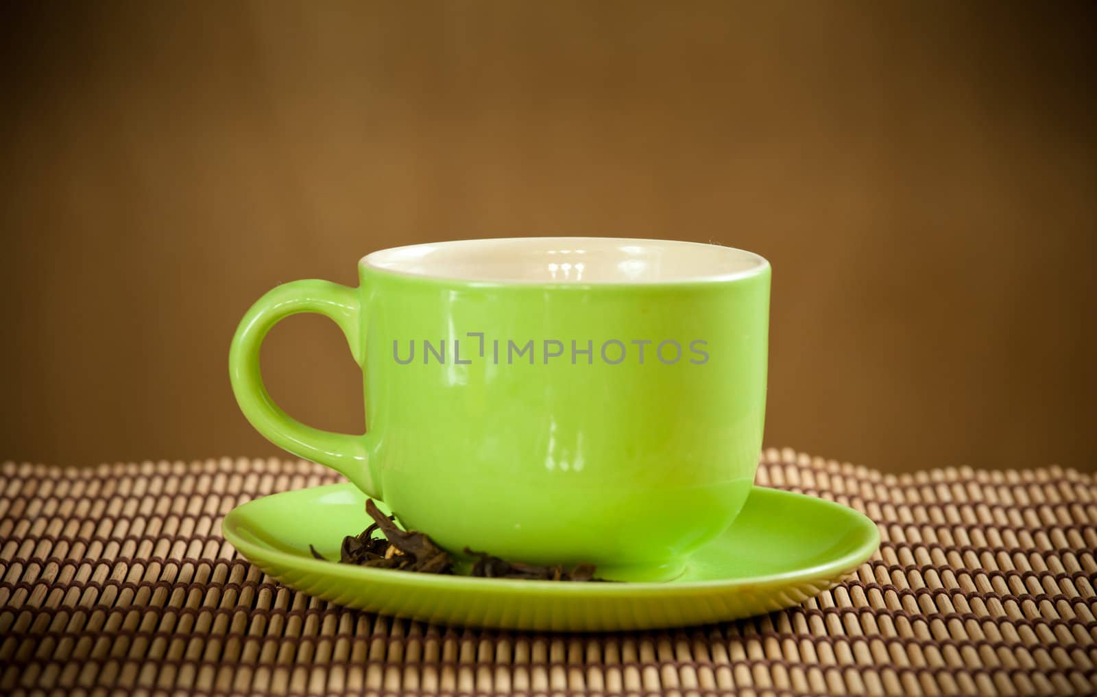 green cup of hot tea on wood background