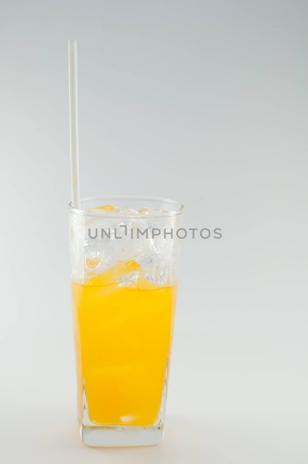 a glass of orange juice on white background