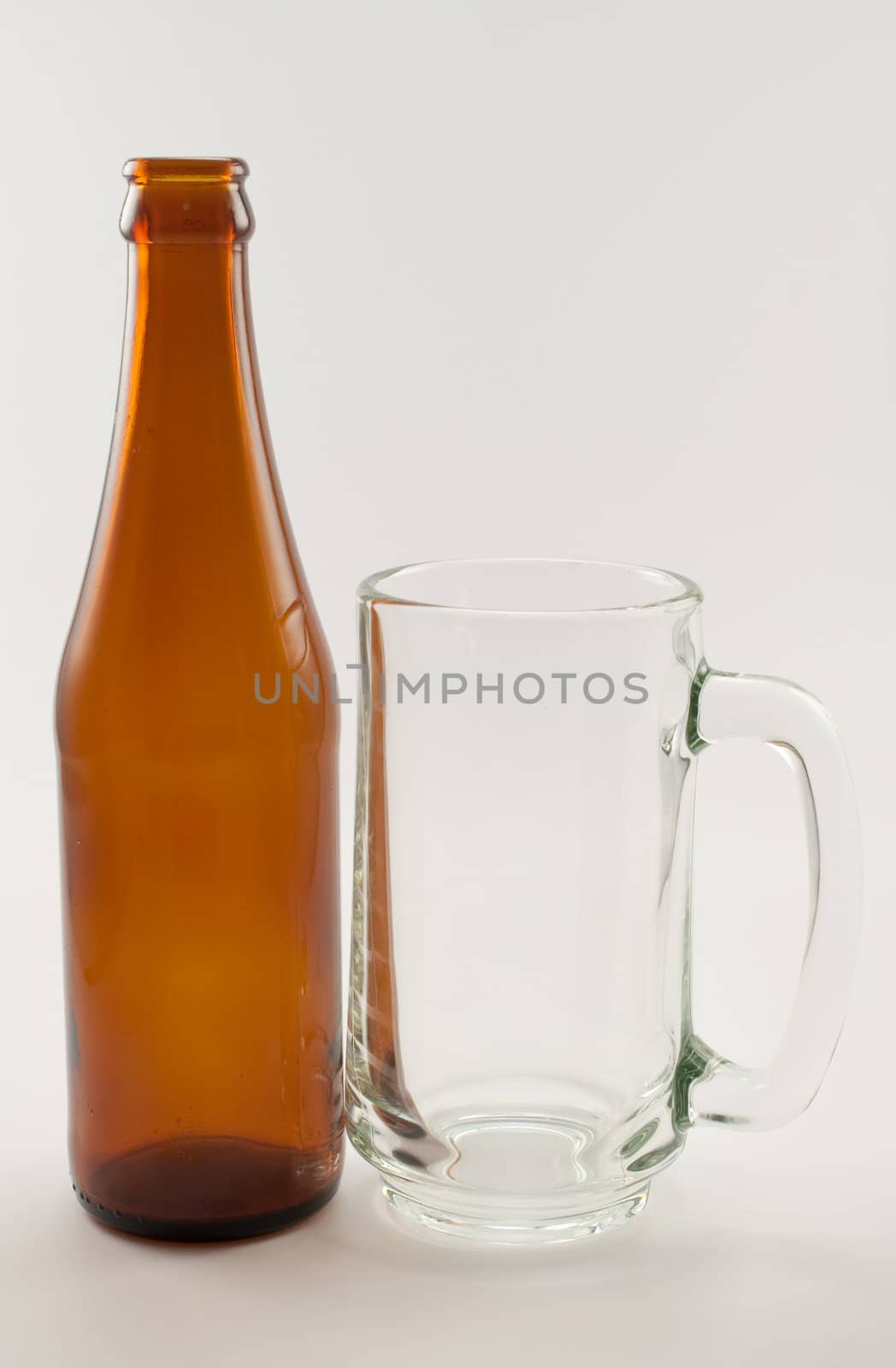 bottle and glass of beer on white background