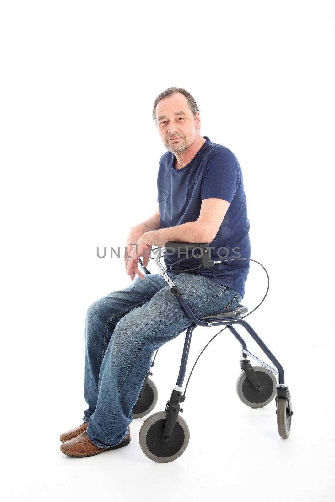 Satisfied middle-aged man resting onthe seat of a health walker which he is using to aid mobility as a result of a disability or injury 