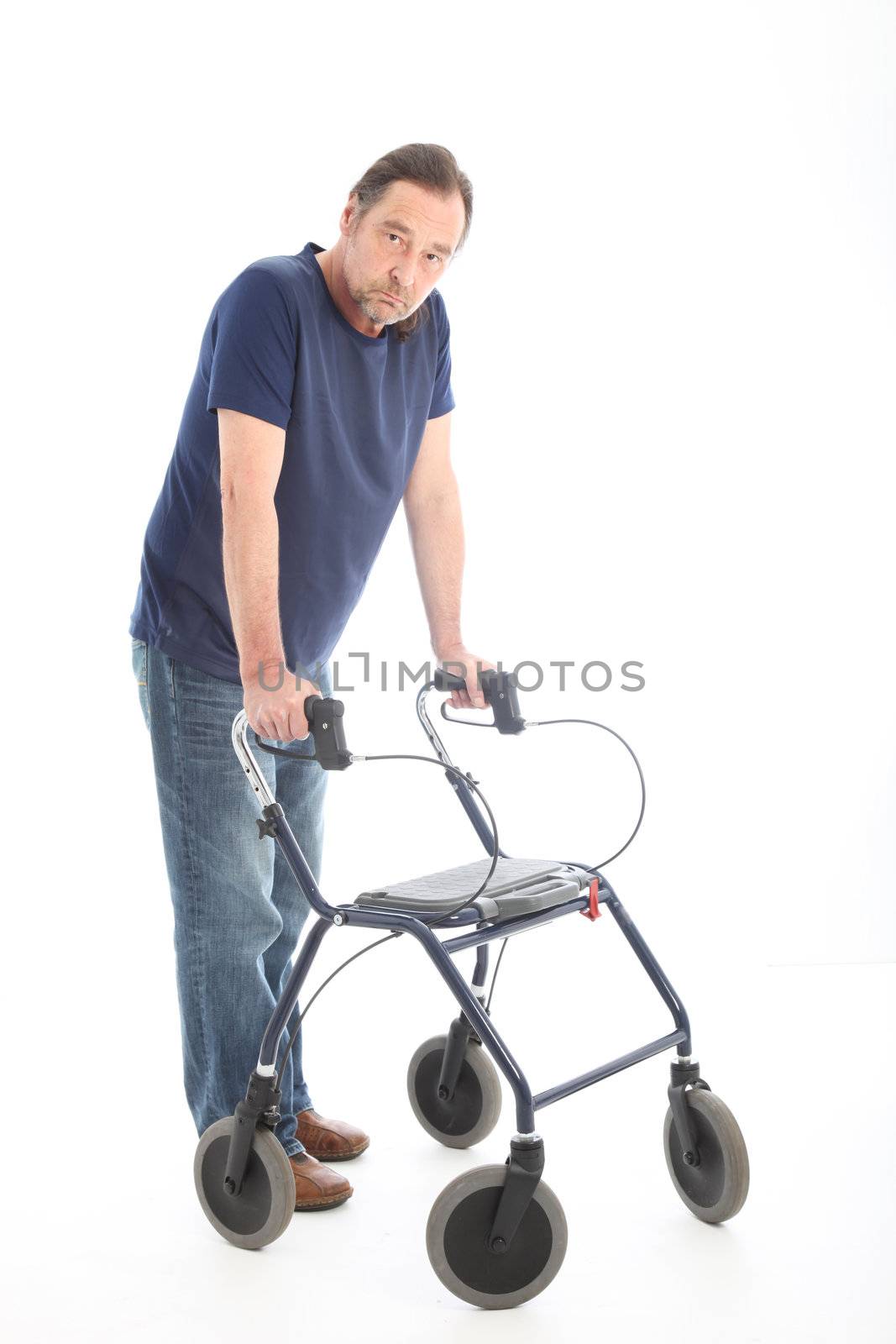 Middle-aged man walking leaning his arms and weight on a medical walker for support and stability following an illness, injury or disability 