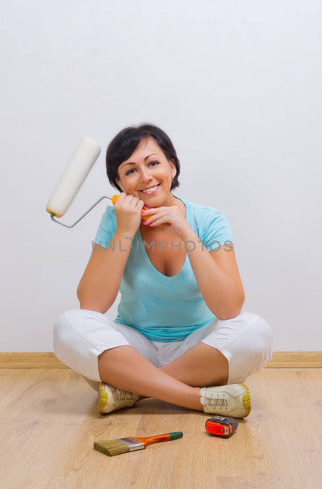 Happy woman with painting roller