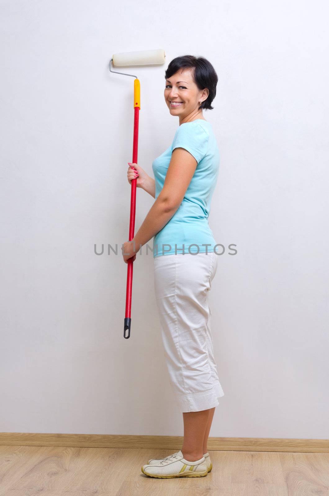 Young woman with painting roller