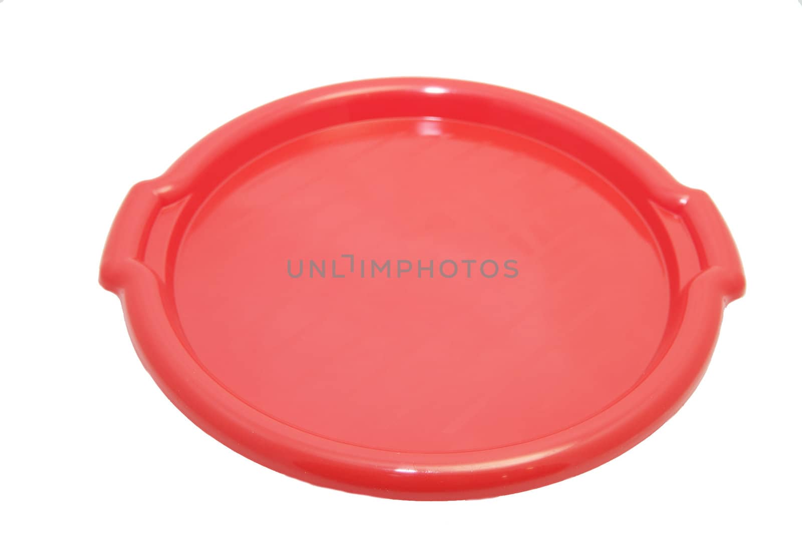 Round red plastic tray on a white background