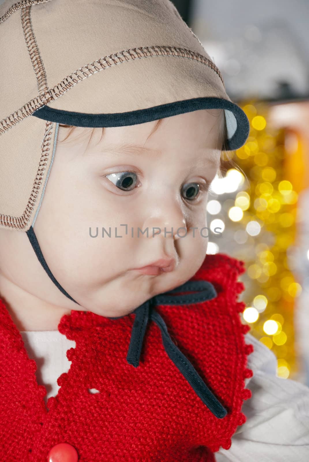 Close-up portrait of a young boy in cap.