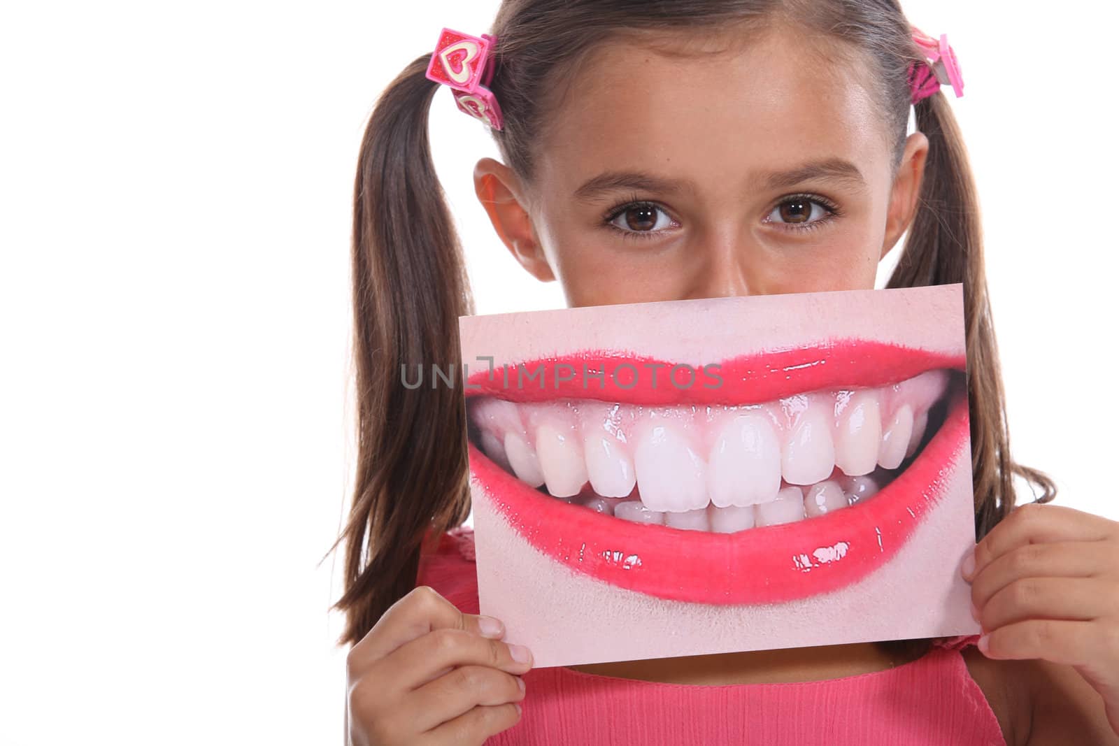 Little girl holding photo of mouth by phovoir