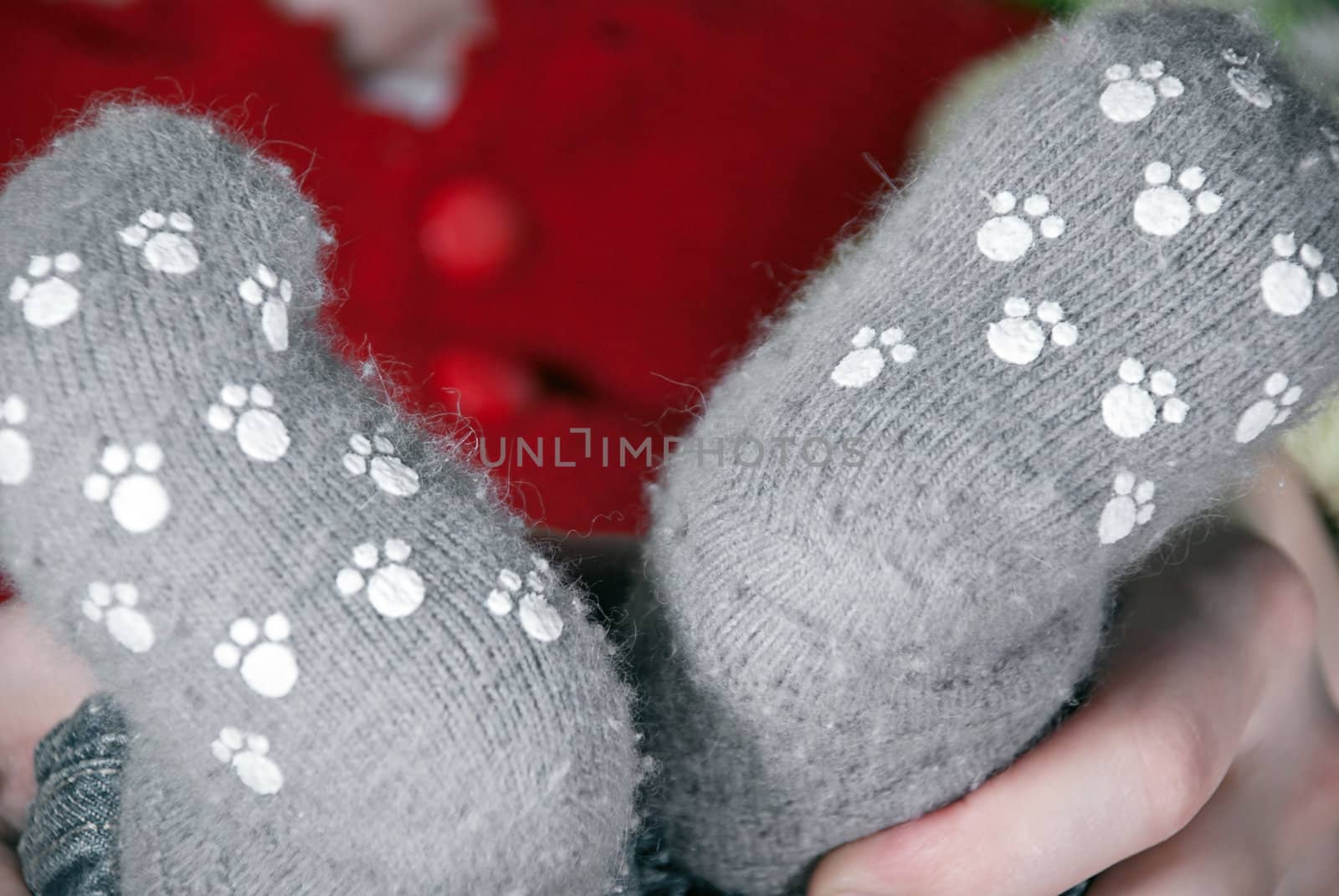 Close-up baby legs in knitted gray socks.