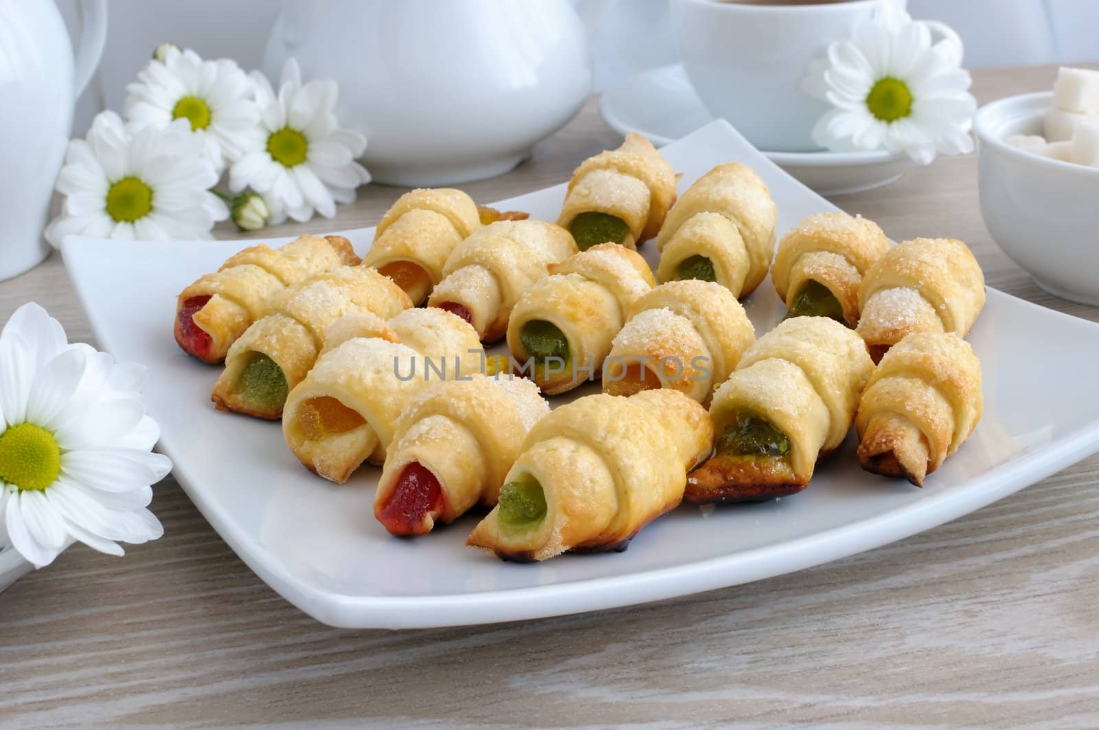 Plate with homemade croissants filled with colorful jelly