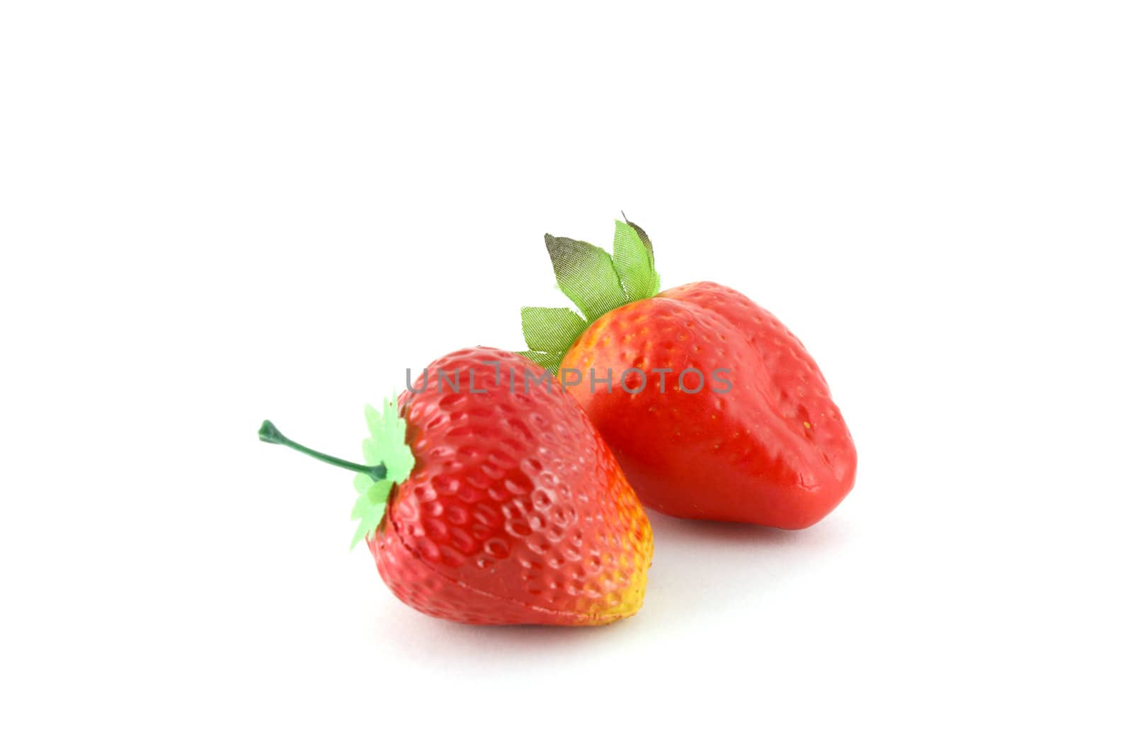 Artificial strawberries over white