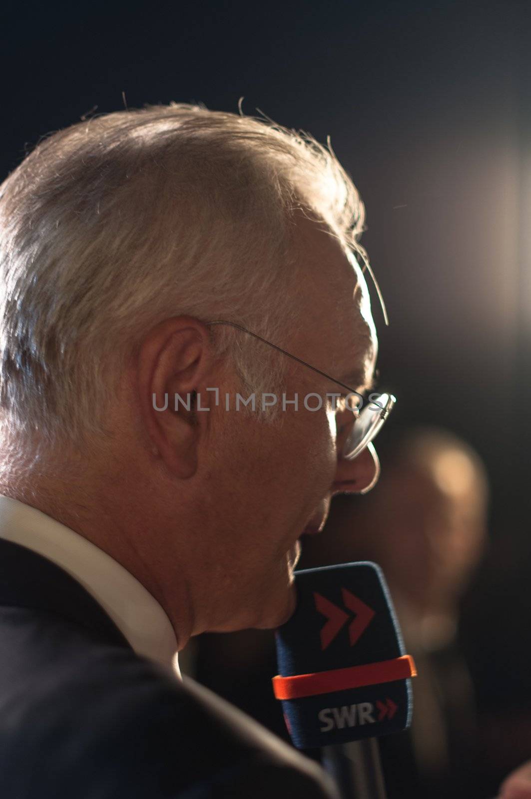 STUTTGART, GERMANY - JULY 25: Harald Schmidt, the most famous German talkmaster, is interviewing guests at the public viewing of the premiere of Mozart´s opera “Don Giovanni” in front of the Opera building in Stuttgart, Germany on July 25, 2012.