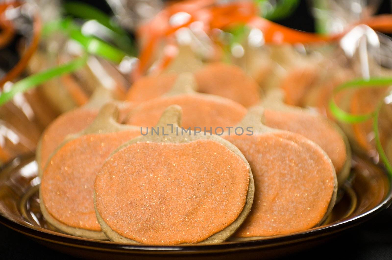 Homemade pumkin cookies on isolated black background.