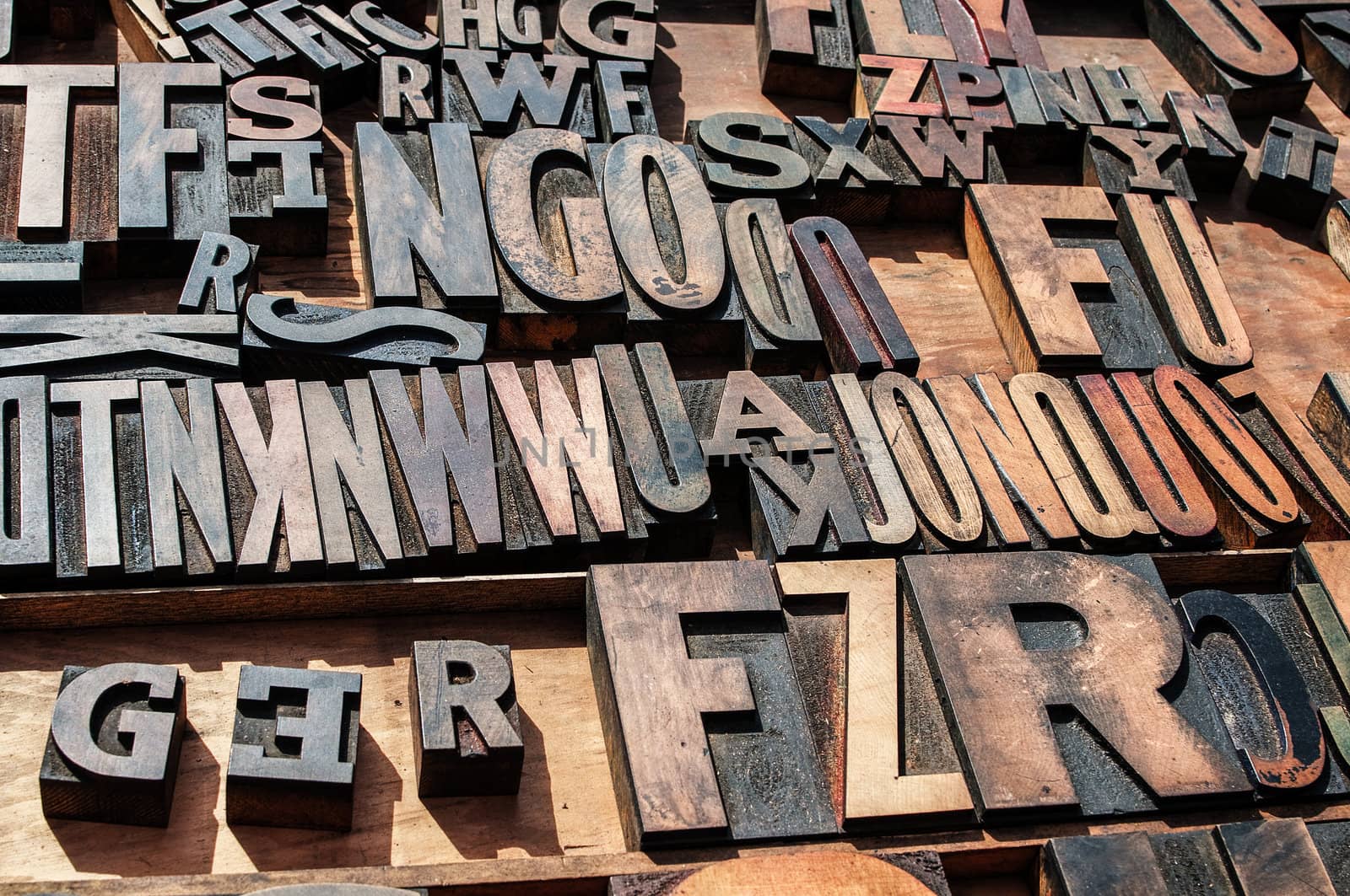 A bunch of old vintage wooden block printing press letters.