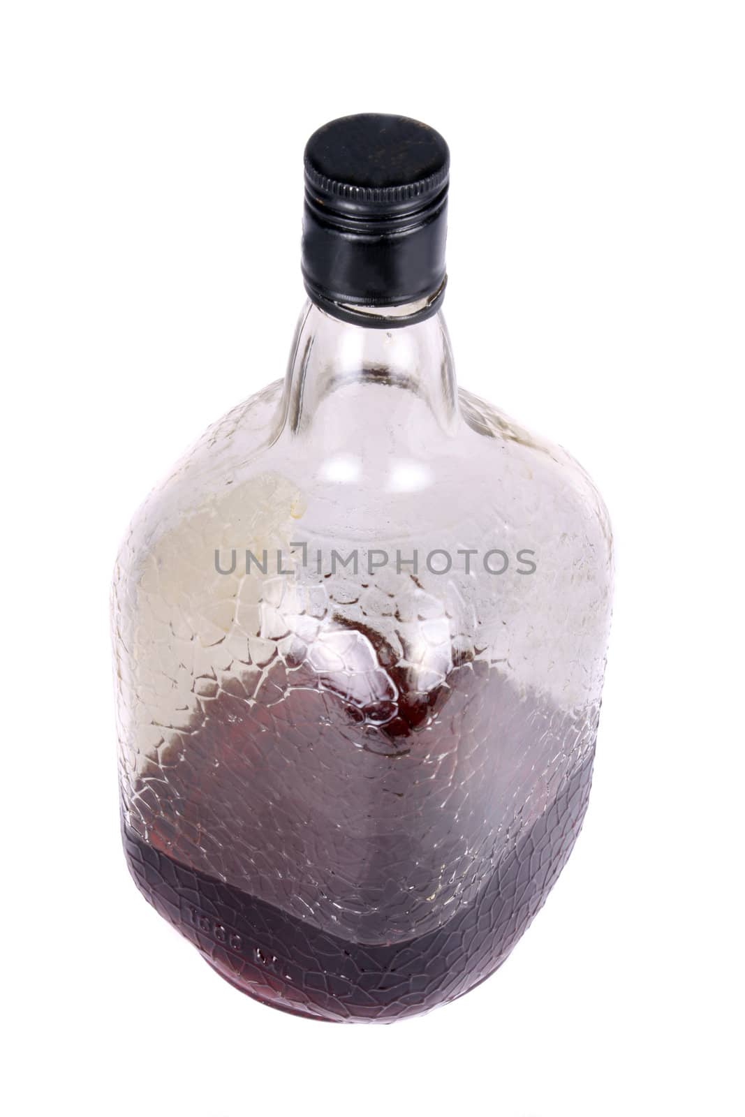 A bottle of dark rum, on white studio background.