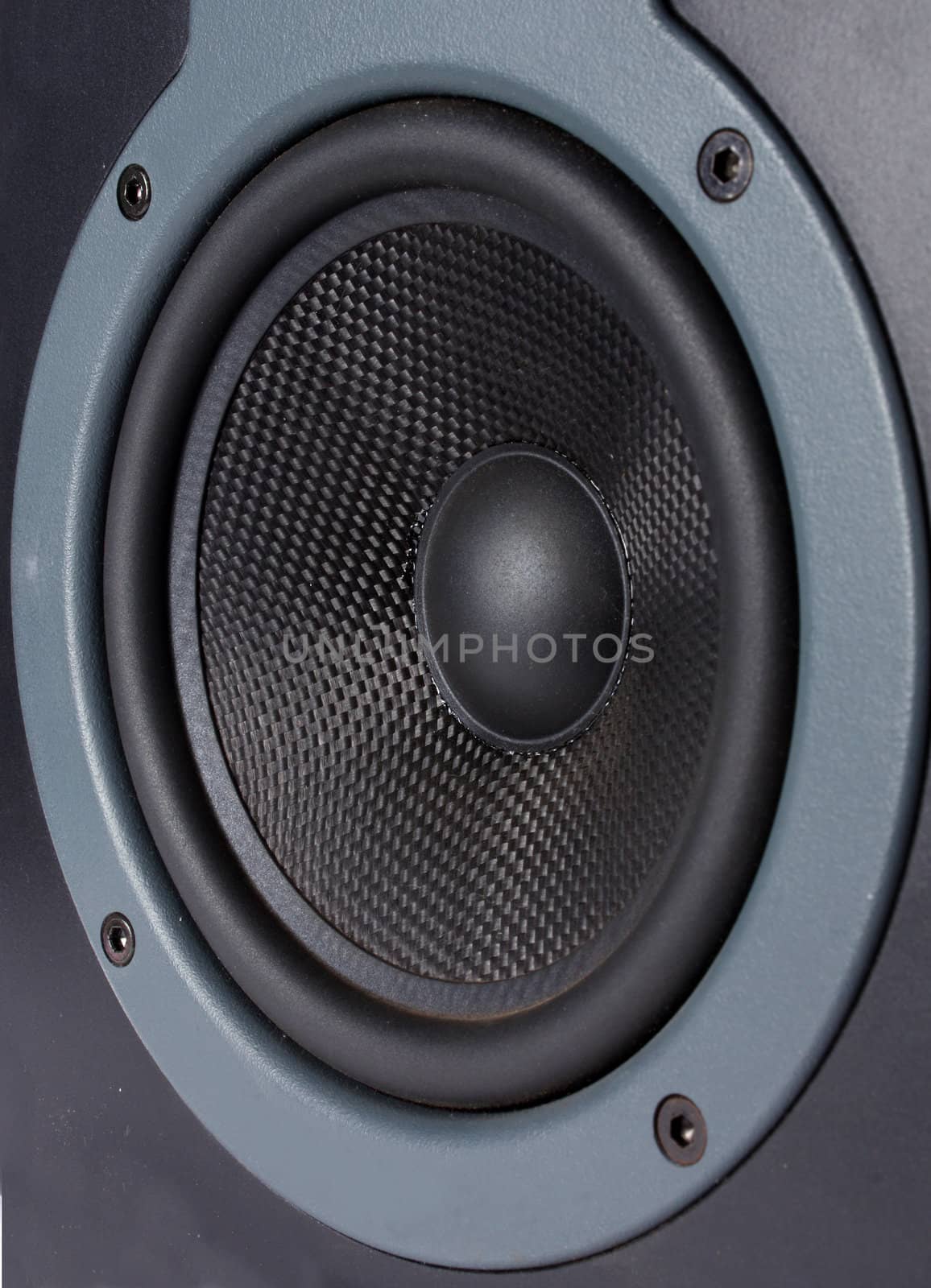 A closeup view of the woofer of a speaker.