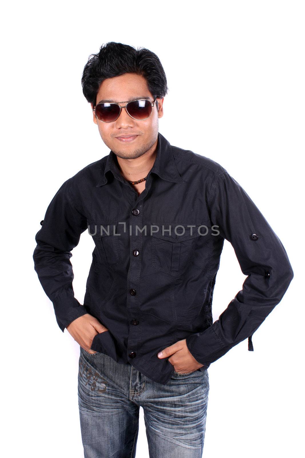 A young Indian man in black shirt wearing sunglasses, on white studio background.