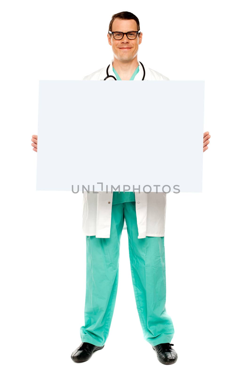 Handsome male doctor displaying white advertising board, full length shot