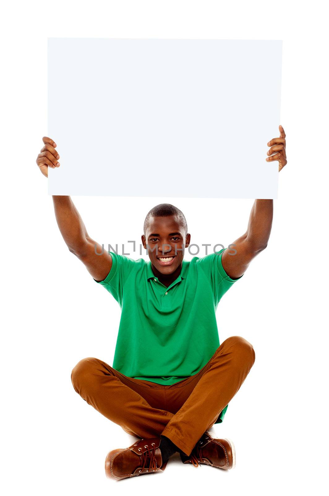 Seated young man holding white blank banner over his head