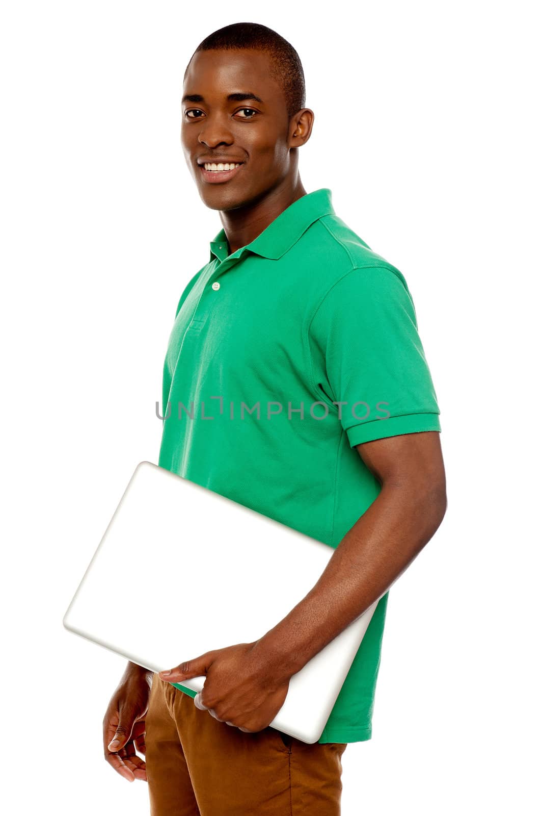 Casual teenager carrying laptop and looking at camera