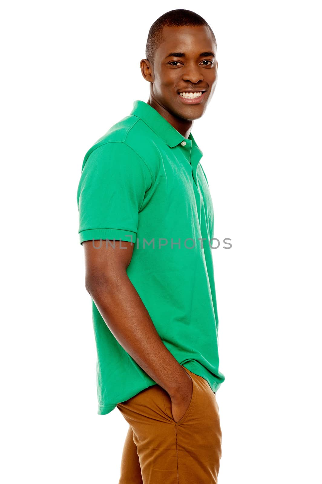 Side view portrait of smiling casual african guy posing with hands in pocket