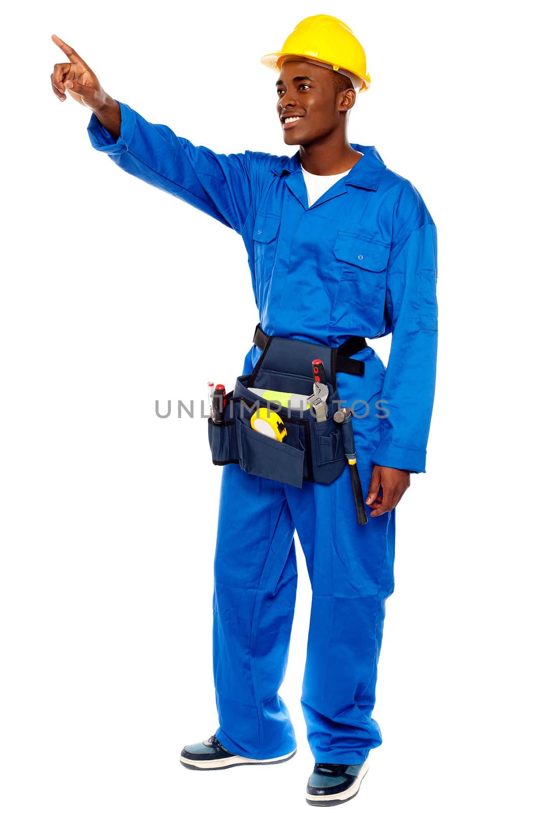 Young african male worker pointing at copy space, full length portrait