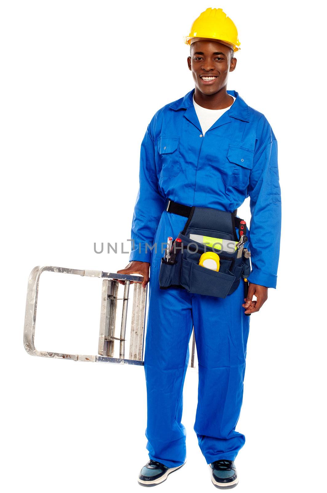 African repairman holding stepladder with tool bag around his waist isolated against white background